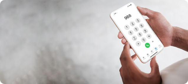 Hand holding phone calling 988